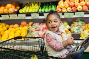 Child in cart in grocery store